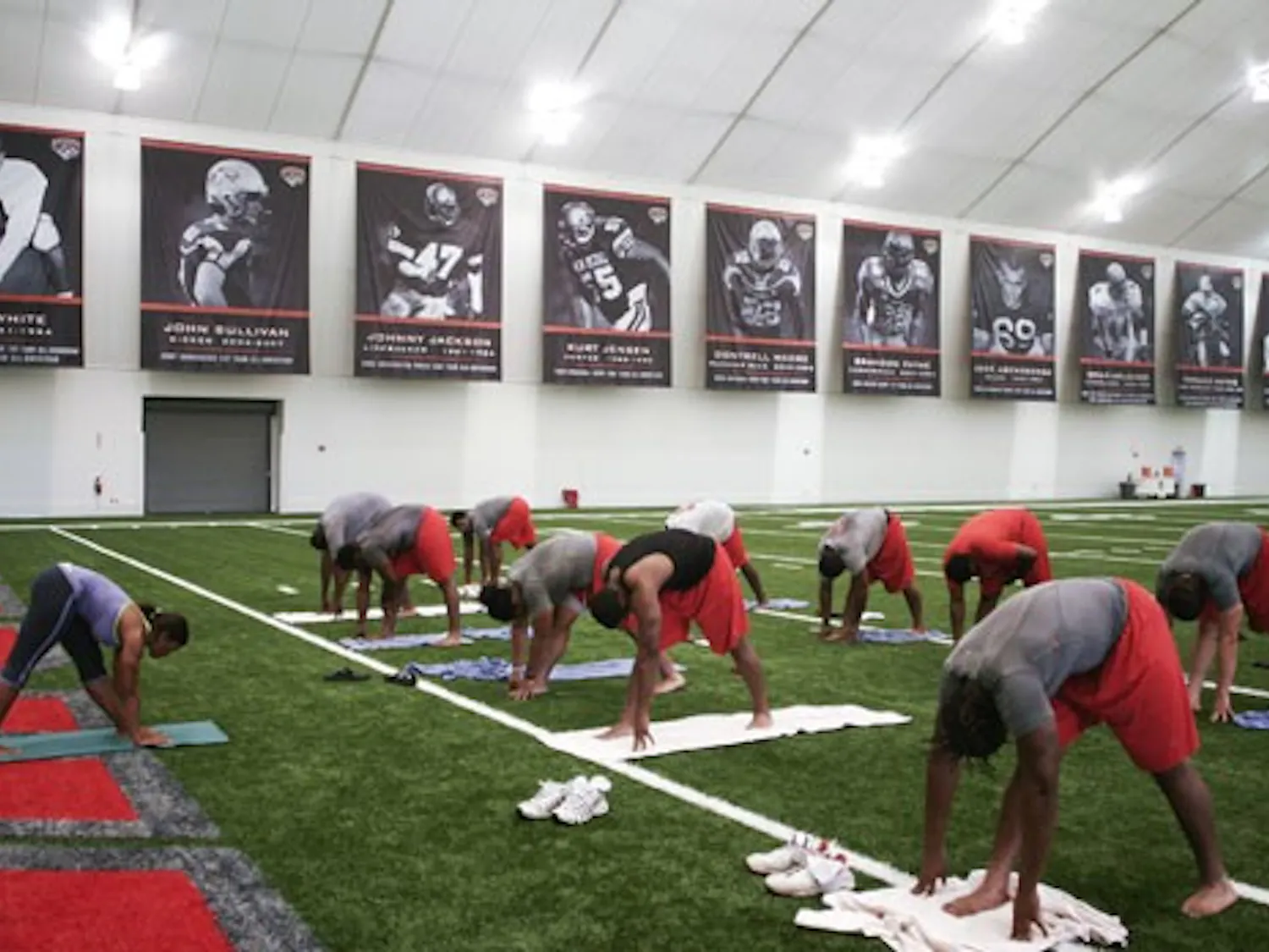 UNM football players Jaymar Latchison, left, and Josh Taufalele meditate during one of the Lobos’ yoga classes at the Indoor Practice Facility on July 22.