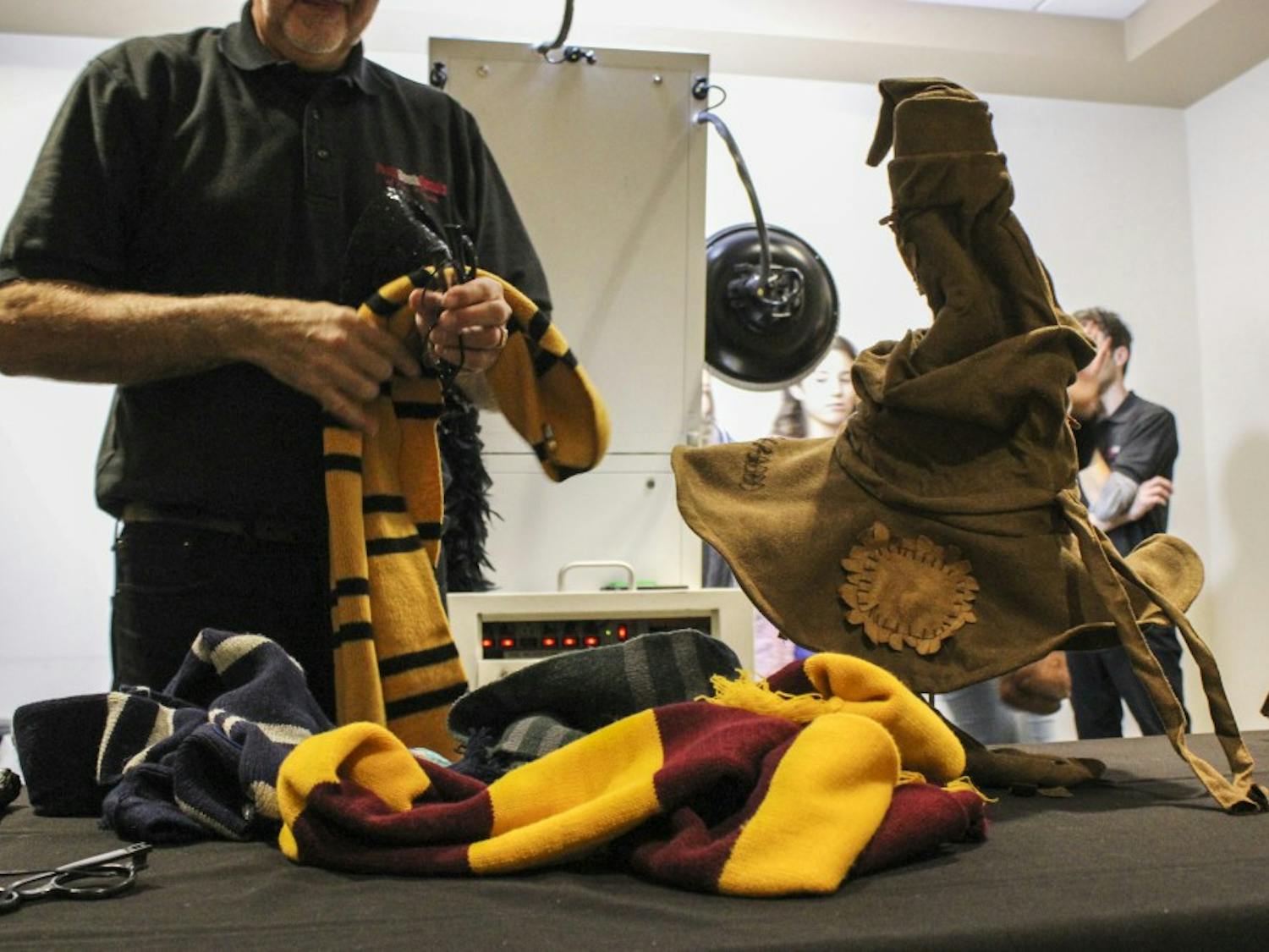 A SUB employee organizes Harry Potter-themed accessories for students who waited to be sorted into their Hogwarts house on Tuesday, Nov. 22, 2016. Harry Potter Day was organized for the third straight year thanks primarily to the efforts of Student Special Events.