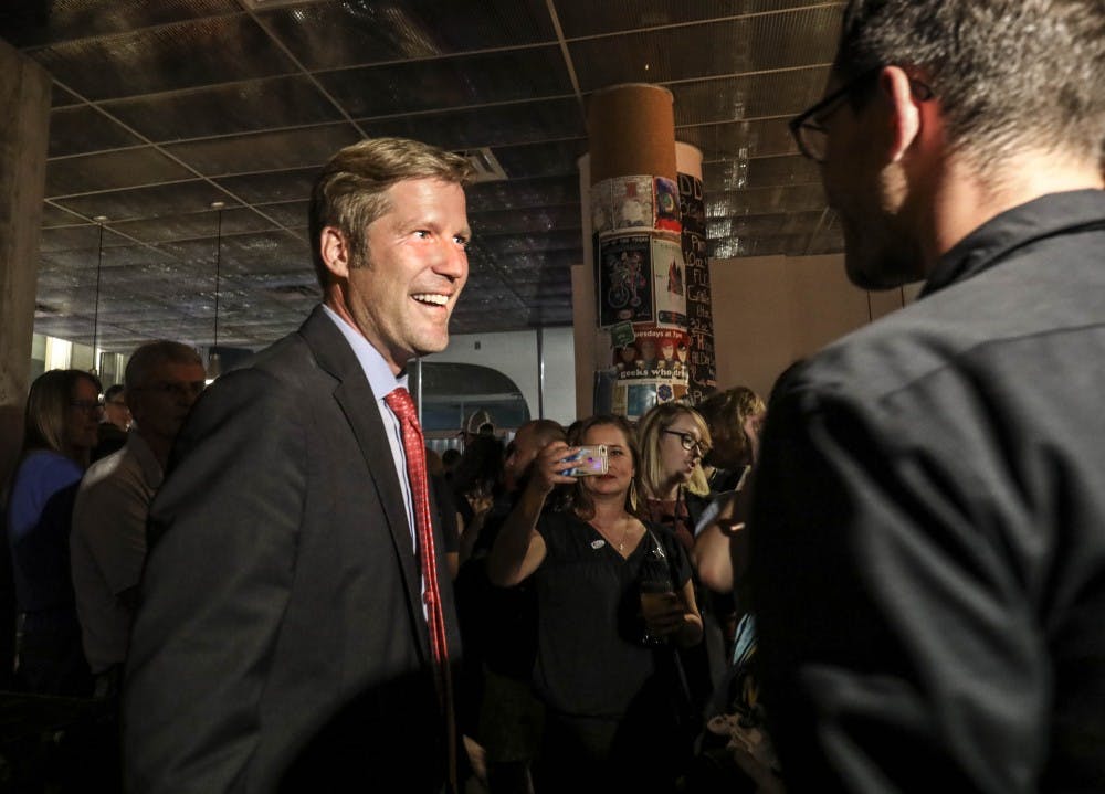 Mayoral candidate Timothy "Tim" Lewis talks with his supporters during the mayoral watch party at Red Door Brewing Company onOct. 3, 2017.