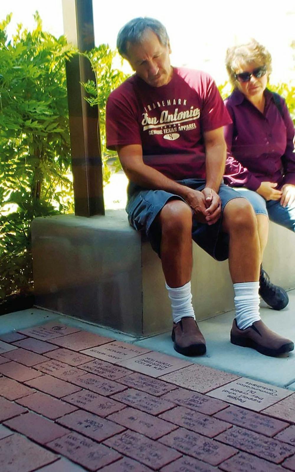 Luis and Ivon Luna look at bricks that were bought as donations for the Communications and Journalism Building. The building, which took more than one year and $6 million to complete, opened to faculty and students Sunday.