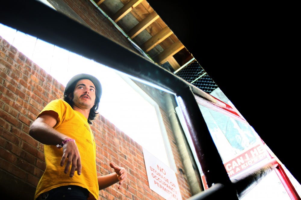 	Dan Lewis walks upstairs from the lower half of the all-ages venue, Warehouse 508, on Monday. Lewis will be leaving the position as venue manager to pursue his career as a DJ.