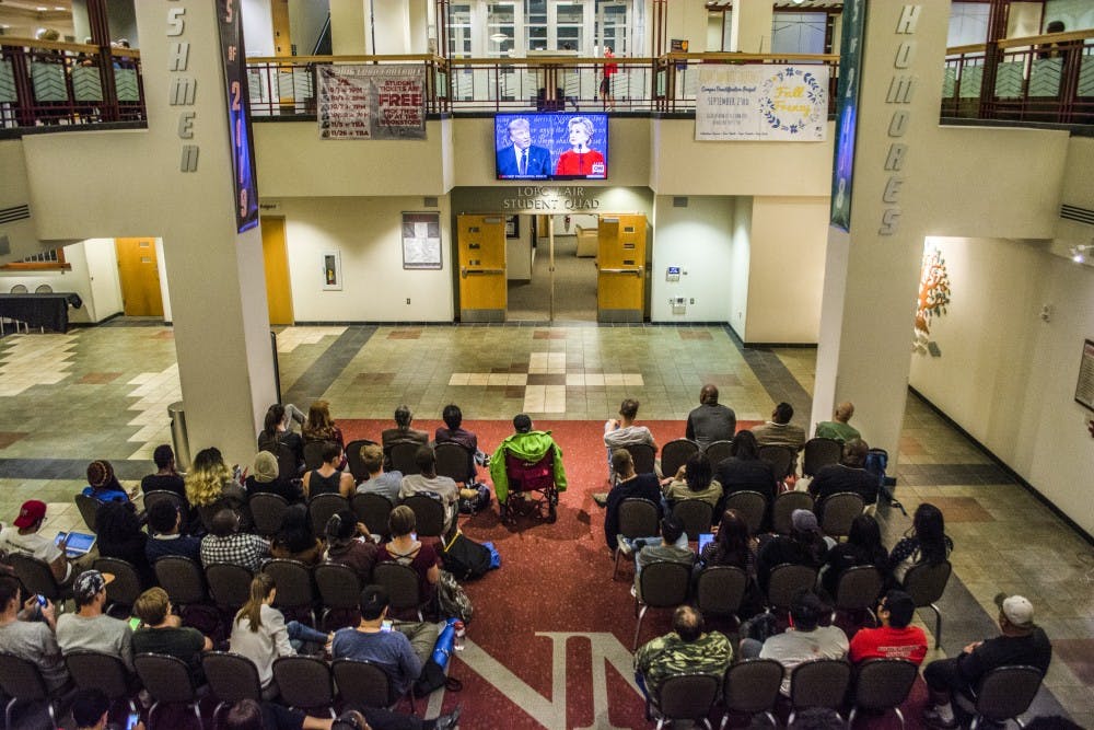 A crowd sits in front of a television in the SUB Atrium Monday Sept. 26, 2016 at UNMs Main Campus. Crowds gathered around various spots on campus to watch presidential candidates Donald Trump and Hillary Clinton in their first debate of this years presidential election.&nbsp;