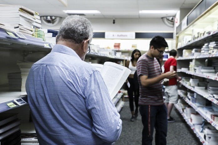 Charles Walker flips through a book at the UNM Bookstore on&nbsp;Tuesday, August 23, 2016. The Bookstore has worked to improve affordability of materials for students.&nbsp;