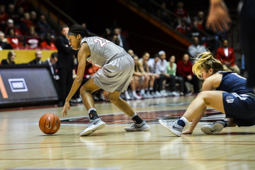 Freshman guard Mykiel Burleson moves around a downed Utah State player Wednesday, Jan. 4, 2016 at WisePies Arena. The Lobos will go up against the UNLV Rebels Wednesday night in Las Vegas, Nevada.&nbsp;