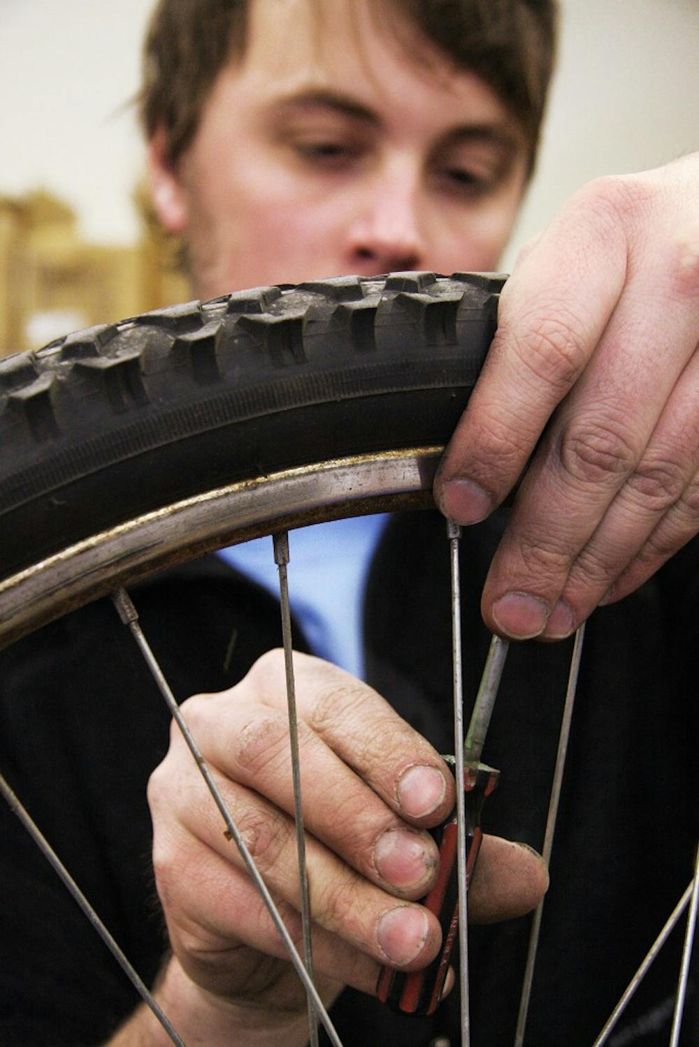 	Charles Gwinn, a student employee at the UNM Outdoor and Bike Shop, works on a repair Monday. The shop is hosting a Gear In Gear Out sale on Friday for students to sell used gear.