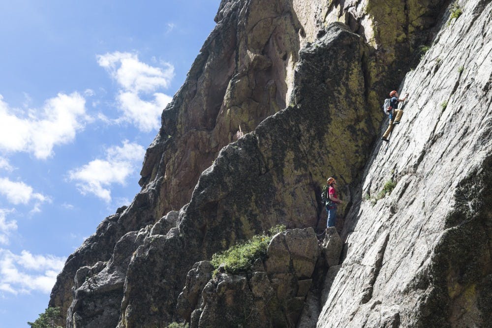 	Marc Beverly and Jimmy Buchannan climb a face of the Sandia Mountains on Sunday. The Sandias have long been the home to rock climbing aficionados from around the world.