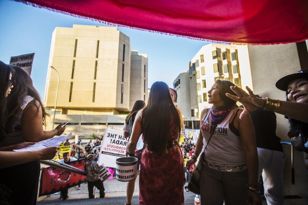 Protesters gather in front of the downtown Albuquerque Police Department office before attendees addressed fellow demonstrators with a loudspeaker.