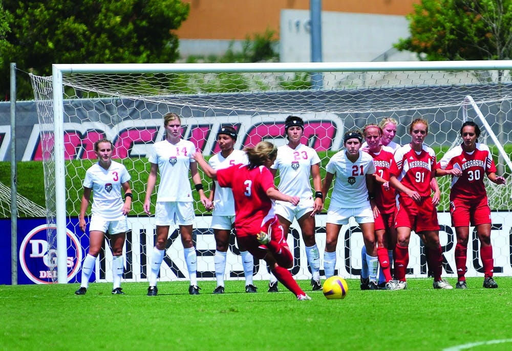 	A Nebraska striker lines up the crosshairs during a free kick on Sunday against the Lobos. The Lobos shut out the Cornhuskers.