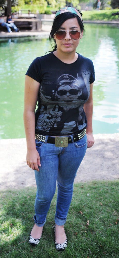 	Kenya Torres, Freshman, Undecided

	Headband:  Vintage store in Santa Fe, $20  
Shirt:  Forever 21, $7
Belt Buckle:  Merchant in Europe, $7
Belt:  Hot Topic, $15
Jeans:  Thrift store, $27 
Shoes:  Dillard’s, $40

	“I really hate those bright colors that they are bringing in, pink with green and blue. I don’t like that.” 

	Kenya’s fashion is inspired by the clothing she has seen while meandering through thrift and vintage stores. She said she folds the cuffs of her jeans up because her pants are too long, so that her pants have a straight leg instead of bunching around the ankles.