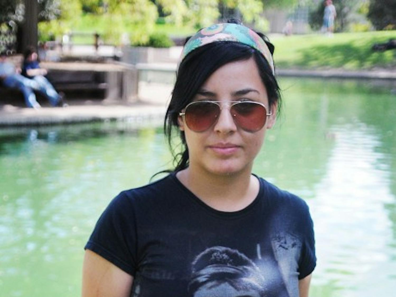 Kenya Torres, Freshman, Undecided
Headband: Vintage store in Santa Fe, $20
Shirt: Forever 21, $7
Belt Buckle: Merchant in Europe, $7
Belt: Hot Topic, $15
Jeans: Thrift store, $27
Shoes: Dillard’s, $40
“I really hate those bright colors that they are bringing in, pink with green and blue. I don’t like that.”
Kenya’s fashion is inspired by the clothing she has seen while meandering through thrift and vintage stores. She said she folds the cuffs of her jeans up because her pants are too long, so that her pants have a straight leg instead of bunching around the ankles.