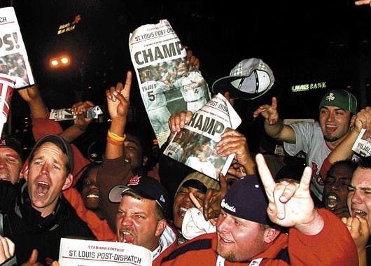 Fans of the St. Louis Cardinals revel in downtown St. Louis after the team wins the World Series on Friday.  
