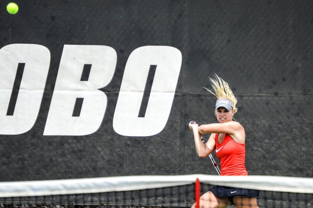 Junior Dominique Dulski swats the ball back to an Air Force player Saturday afternoon at the McKinnon Family tennis Stadium. The Lobos beat Air Force 6-1.