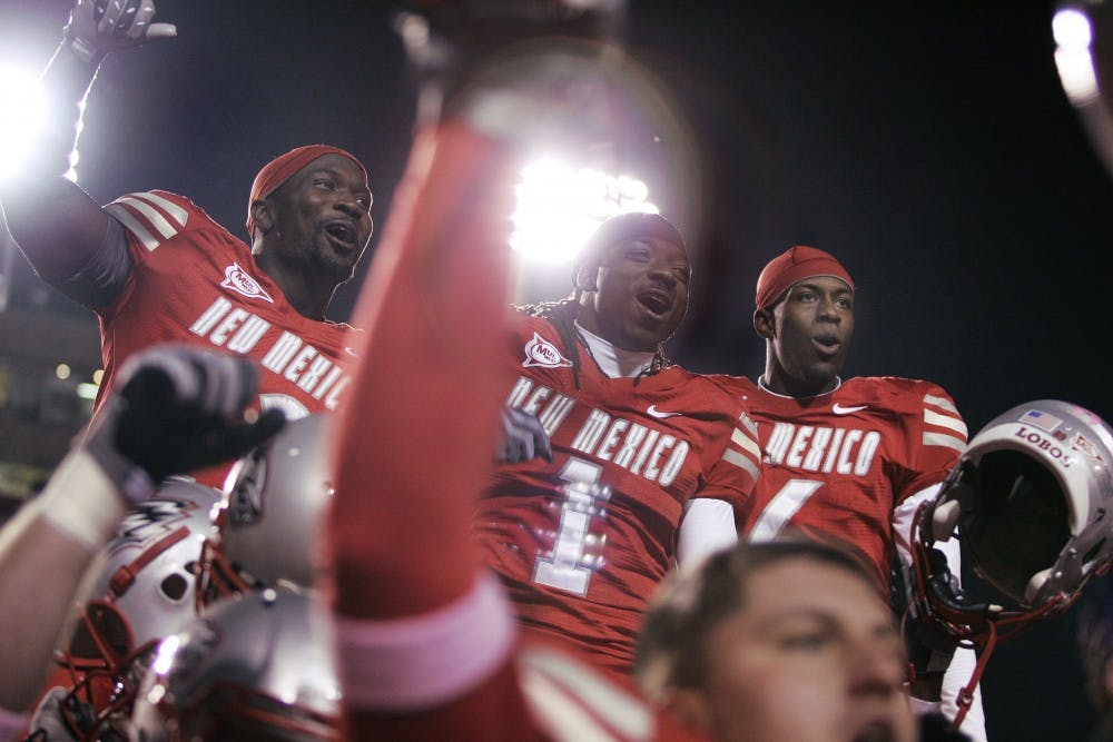 	Demond Dennis, middle, celebrates alongside fellow running back James Wright, left, and cornerback Anthony Hooks, right. UNM won its first game of the season, a narrow 29-27 win over Colorado State.

