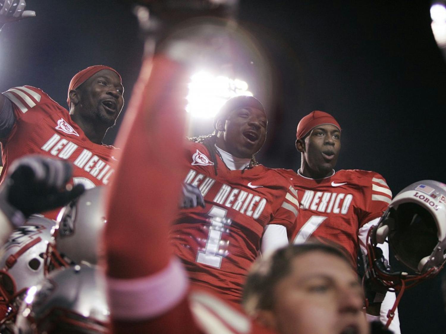 	Demond Dennis, middle, celebrates alongside fellow running back James Wright, left, and cornerback Anthony Hooks, right. UNM won its first game of the season, a narrow 29-27 win over Colorado State.

