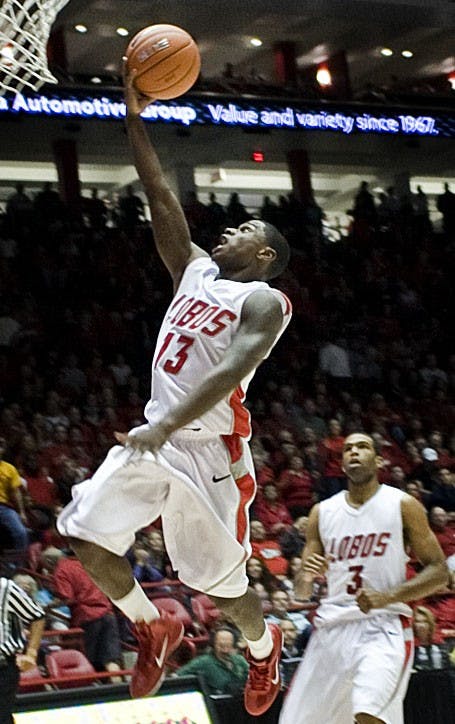 	UNM’s Jamal Fenton attempts a layup as teammate Curtis Dennis watches in the background Saturday. Fenton scored a game-high 23 points as the Lobos defeated Manchester College. 107-62 at The Pit. 
