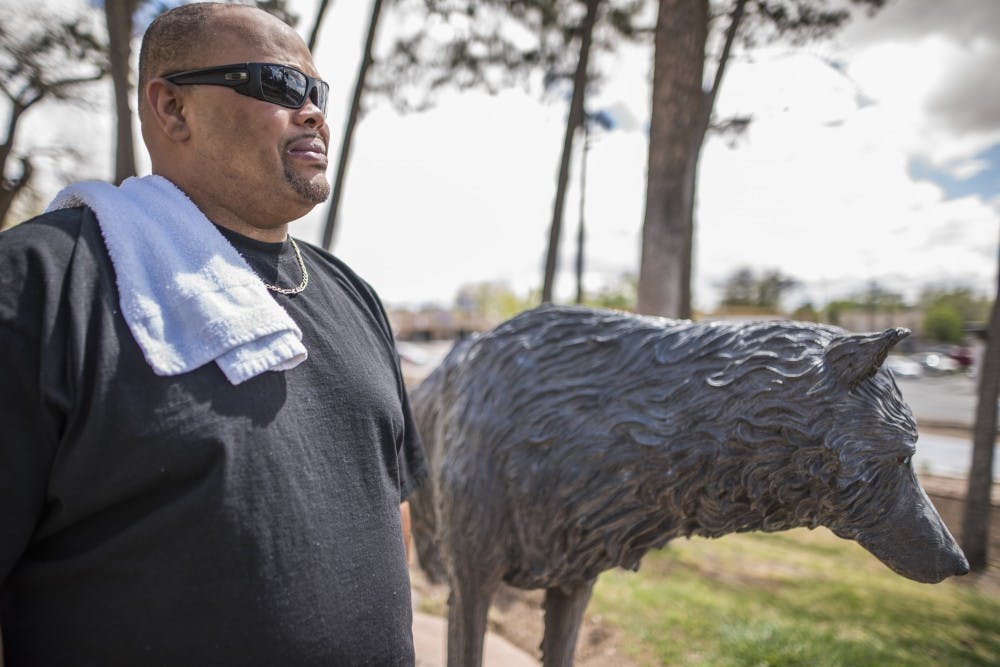 Joseph Haynes stands next to a Lobo statue on UNM Main Campus on Sunday, April 2, 2017. Haynes is a UNM student who formerly suffered from homelessness while being enrolled at the University.