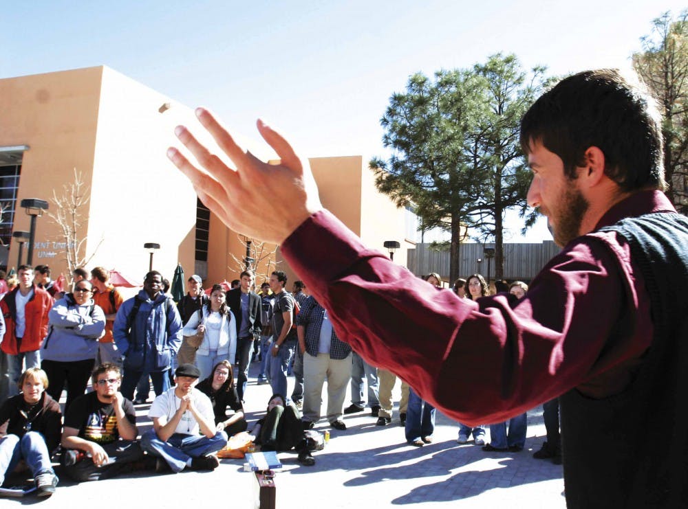 Eli Brayley from Open Air Outreach, a traveling ministry program, speaks to a crowd of students in Smith Plaza on Tuesday. Brayley's group will be in Smith Plaza again today at noon.