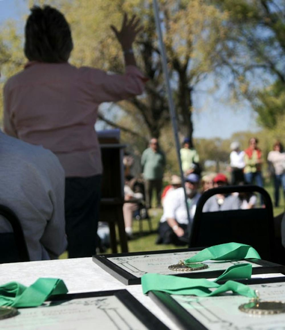 Lt. Gov. Diane Denish speaks with members of the Neighbors for Greenspace on Sunday at the UNM North Golf Course. The organization gave medals to elected officials for their efforts in protecting the course.