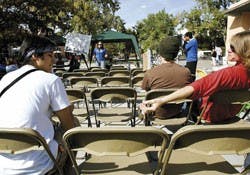 UNM student Chris Cade, right, passes Shaun Griswold a hand-rolled cigarette during a forum Wednesday outside the SUB about banning smoking on campus. The event was co-sponsored by Expose and the Coalition for a UNM Smoke-Free Campus.