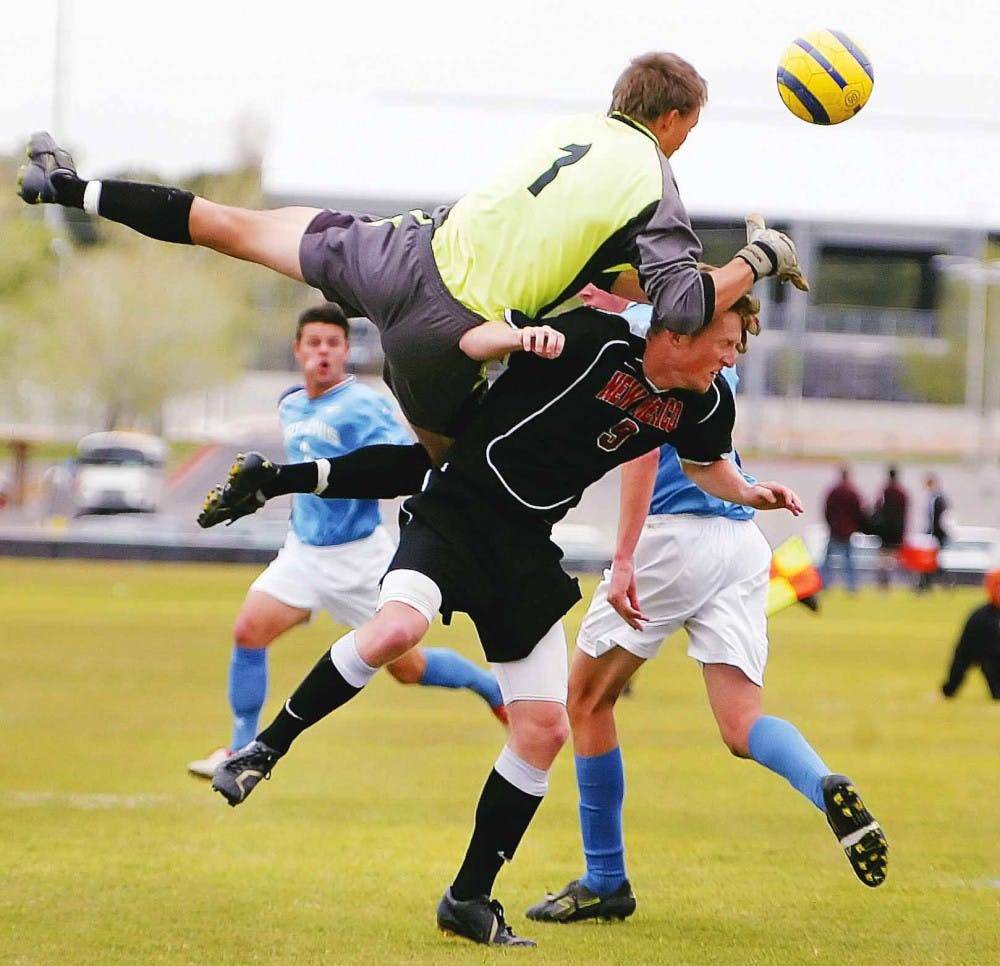 Fort Lewis goalkeeper Zane Wells collides with UNM's Stephen Brown during an exhibition game at Robertson Field on Saturday. The Lobos won 1-0.