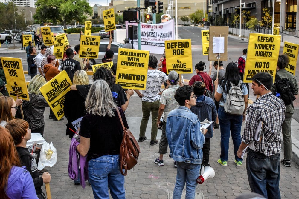 Protesters gather on the southwest corner of 1st Street and Central Avenue to protest Brett Kavanaugh's senate confirmation, Monday, Oct. 1.