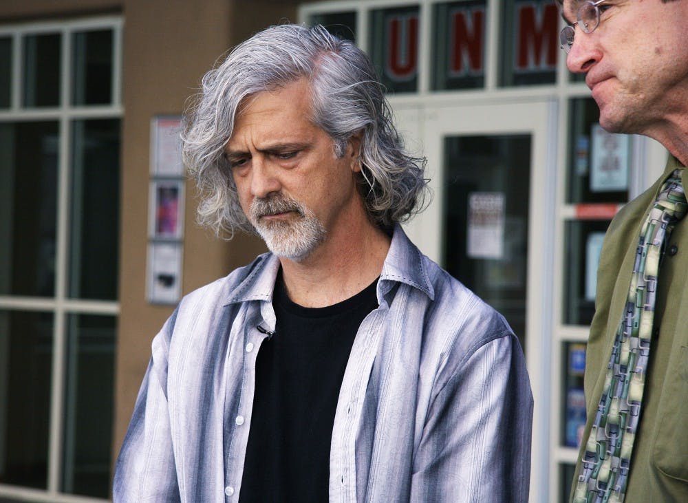 	Former UNM faculty senate president Doug Fields, left, listens to his successor, Richard Wood, speak during a press conference Monday in front of the UNM Bookstore. Fields resigned almost two months before his term ended.