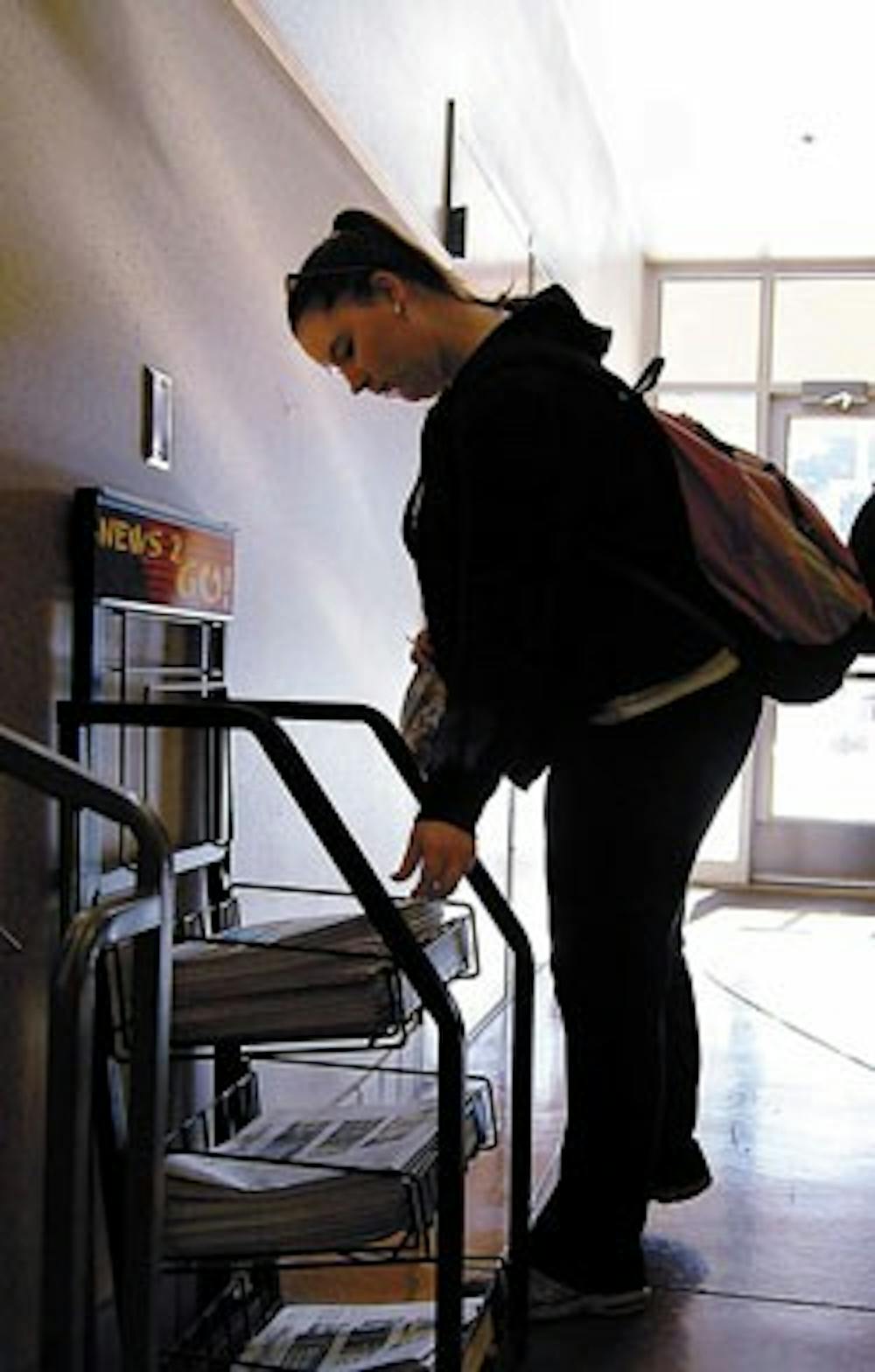 Student Elizabeth Stauss picks up a free copy of USA Today in Dane Smith Hall on Wednesday. The New York Times is also now available for free on campus.