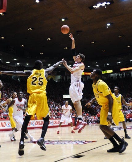 Daniel Farris shoots a hook shot over Djibril Thiam. The Lobos won 86-57 at The Pit on Tuesday night.