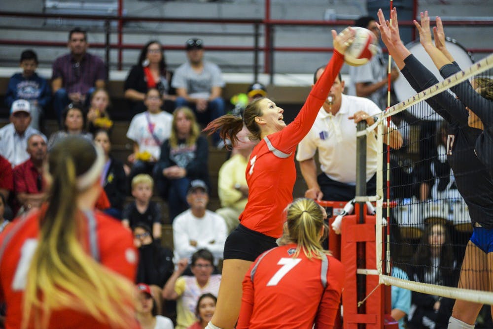 Senior outside hitter Devanne Sours spikes the ball against two Boise State blockers Saturday Sept. 24, 2016 at Johnson Center.&nbsp;