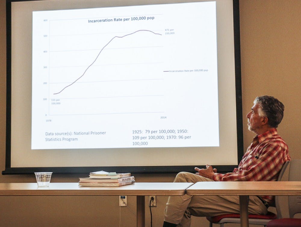 Richard Ross looks at the incarceration rate graph during Maria Valdez's presentation on Tuesday, Oct. 18, 2016. The panel discussion consisted of talks about juvenile incarceration.