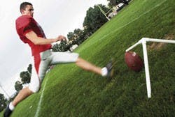 UNM kicker Kenny Byrd place-kicks during practice Wednesday at the Lobo football practice field