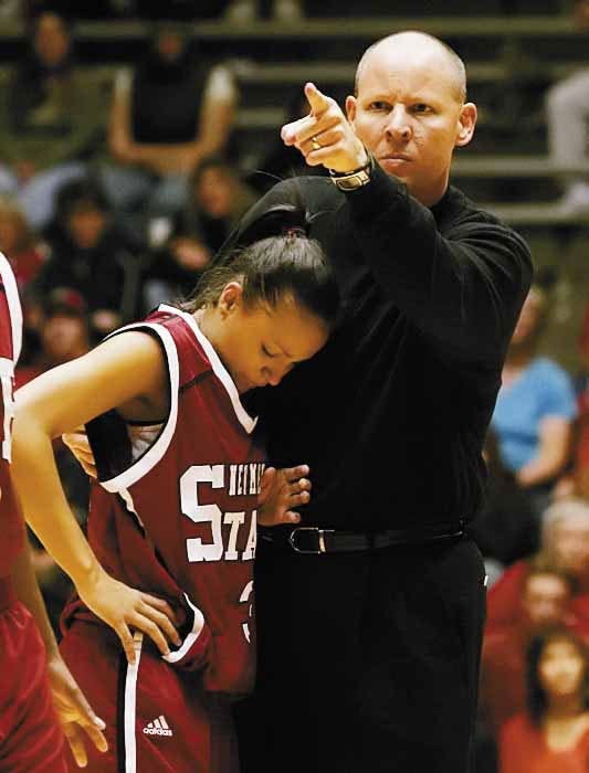 NMSU guard Jazmyn Foster leans on head coach Darin Spence after being knocked to the ground during Saturday's 81-47 loss to the Lobos at The Pit. 