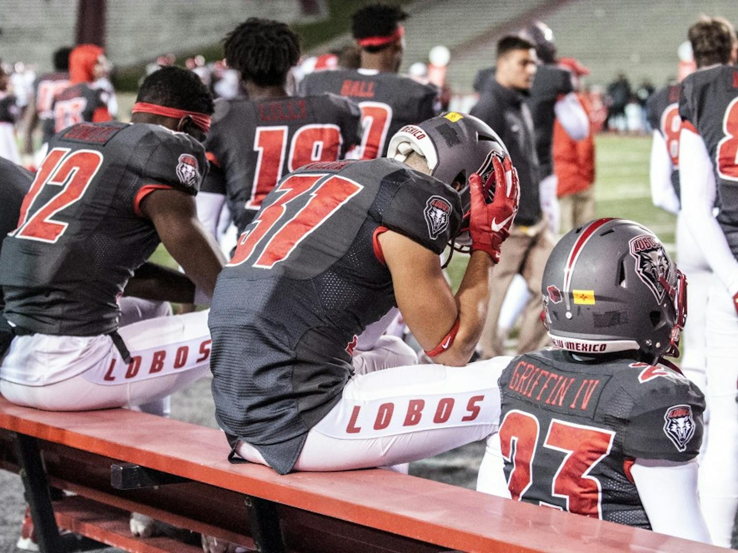 Wide receiver Thomas Vieira (center) holds his head in his hands as the clock winds to zero during UNM’s loss to San Diego State. The Lobos gave up 17 straight points in the fourth quarter, throwing away their nine point lead.&nbsp;