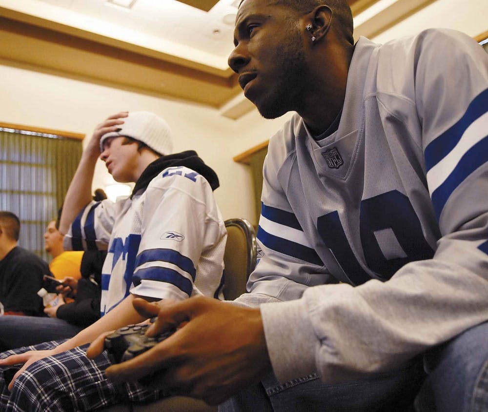 Student Zach Grant, left, looks away while Kevin Harden scores a touchdown during a game of Madden football in a tournament sponsored by Black Men in Motion on Wednesday in the SUB. 
