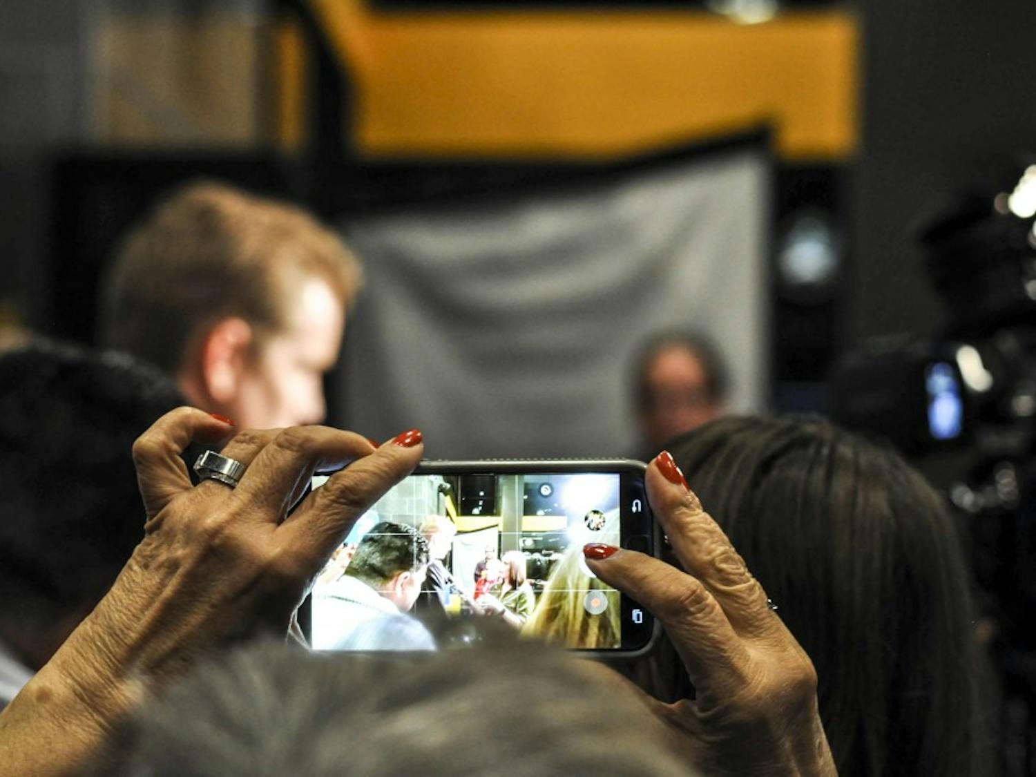 A supporter captures a photo of Mayoral candidate and City Councilor Dan Lewis as he speaks to media at an election viewing party on October 3, 2017 at Flix Brewhouse.