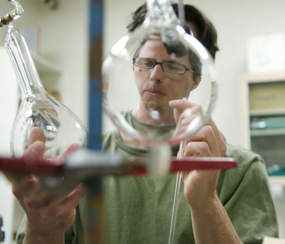 	Ph.D. student Mel Strong examines some of his water vapor measuring instruments in Northrop Hall on Monday. Strong is researching the origin of monsoon moisture in the Southwest and created his own instruments for the experiment.