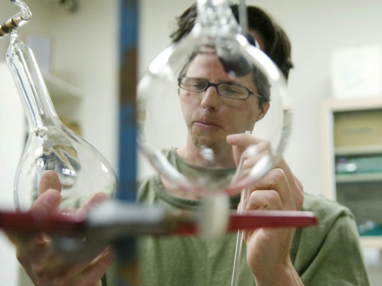 Ph.D. student Mel Strong examines some of his water vapor measuring instruments in Northrop Hall on Monday. Strong is researching the origin of monsoon moisture in the Southwest and created his own instruments for the experiment.