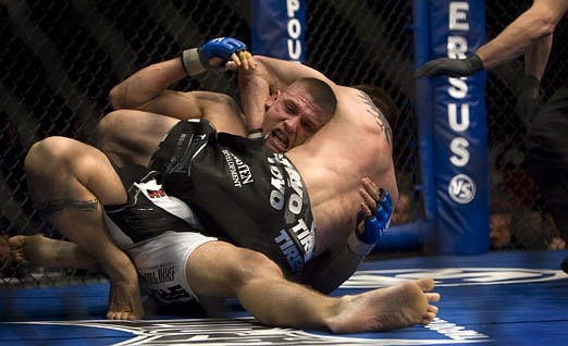 Carlo Prater, white trunks, taps out as Carlos Condit holds him in a headlock during the World Extreme Cagefighting event at the Santa Ana Star Center on Wednesday. Condit beat Prater in Round One, successfully defending his WEC welterweight title.
