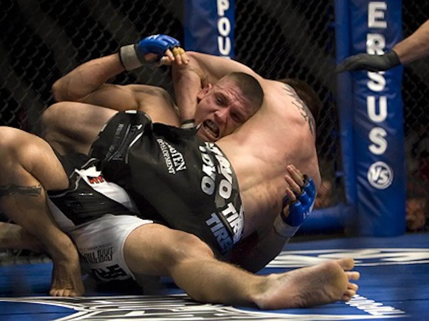 Carlo Prater, white trunks, taps out as Carlos Condit holds him in a headlock during the World Extreme Cagefighting event at the Santa Ana Star Center on Wednesday. Condit beat Prater in Round One, successfully defending his WEC welterweight title.