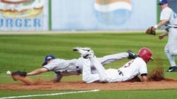 UNM's Dane Hamilton, No. 9, dives back to second base after hitting a double and driving in two runs, while Air Force's Andrew Vasquez dives to catch a ball from catcher Bob Carpenter. The Lobos beat Air Force 26-11 during Friday's game at Lobo Field.