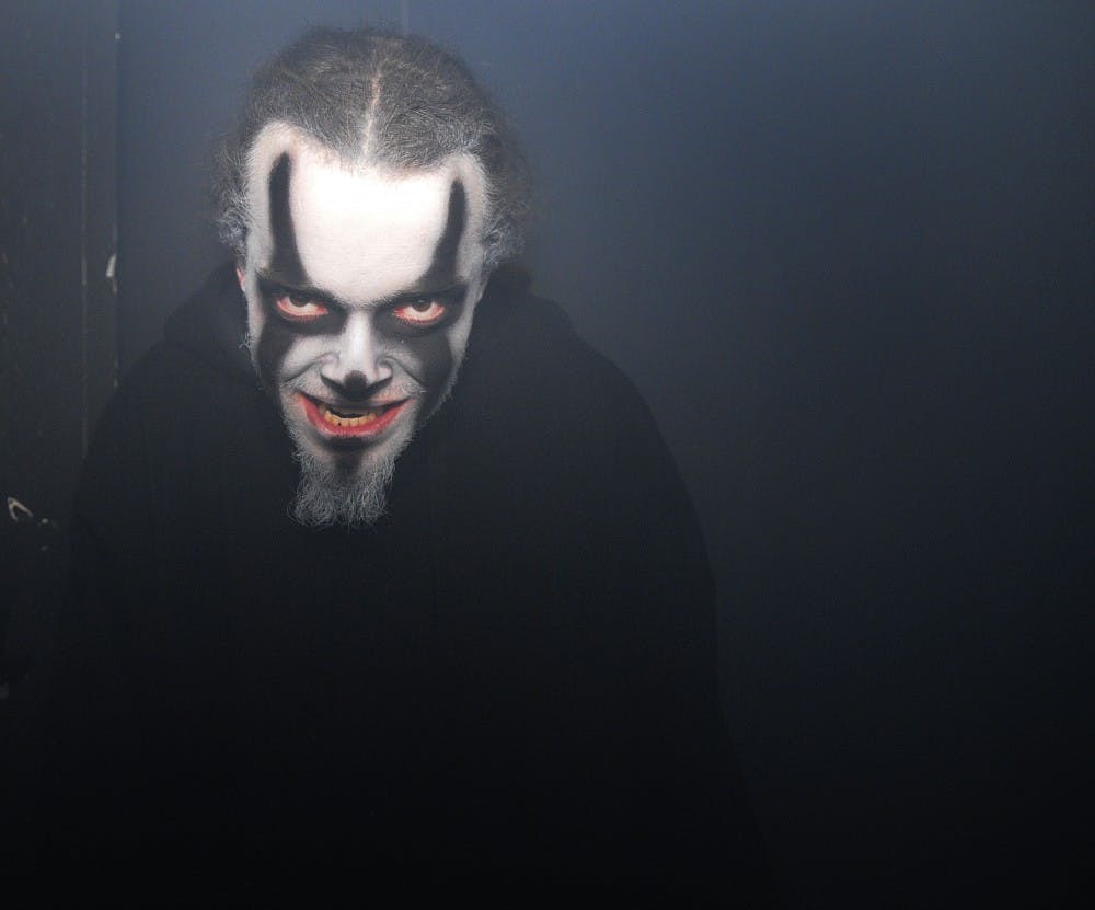 	An actor in Primitive Fear gears up in a hallway to scare the next group of visitors.