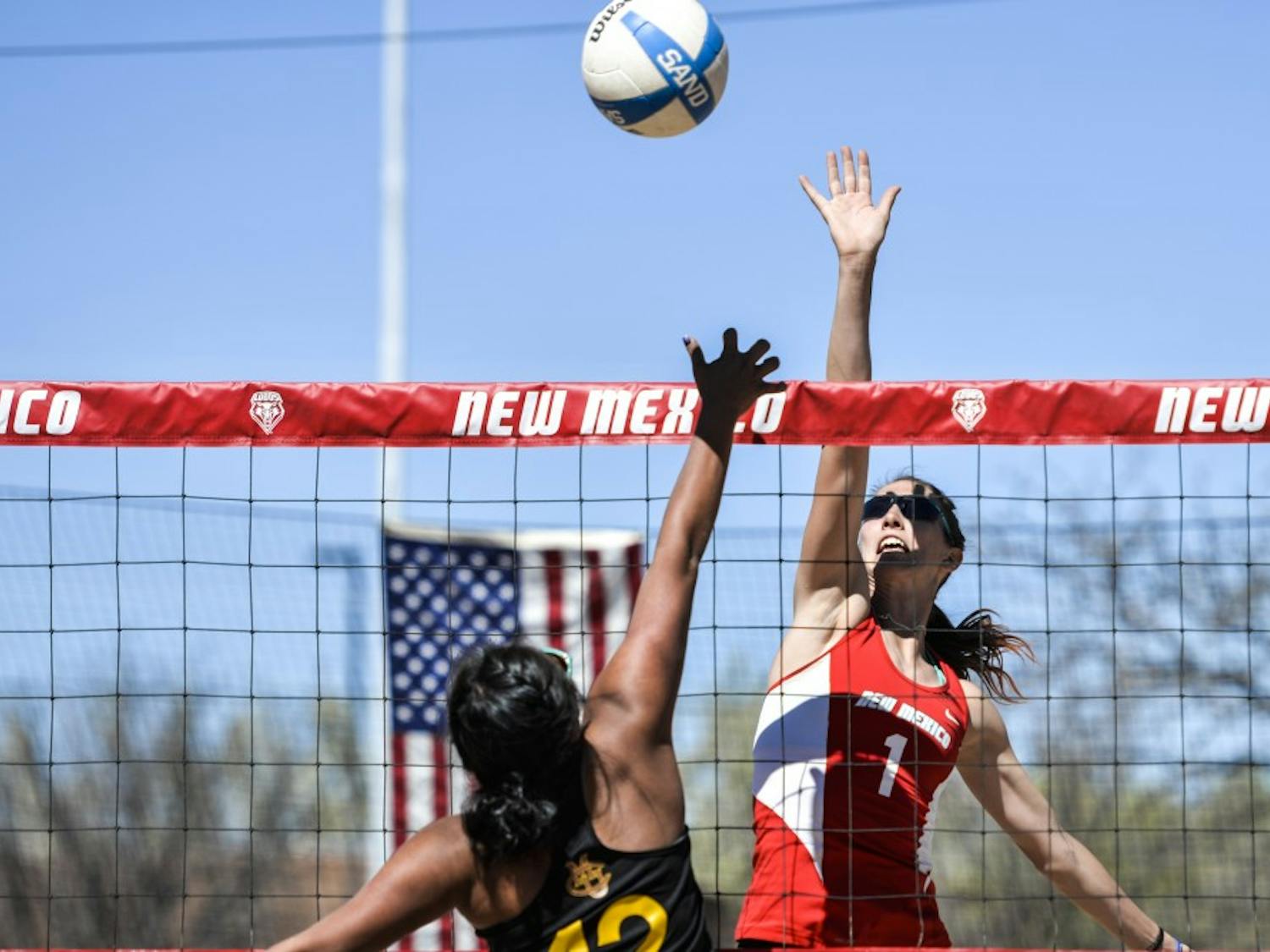 Junior Devanne Sours attempts to block a Colorado Mesa player Friday afternoon at the Lucky 66 Bowl beach volleyball courts. The Lobos beat the Mavericks 5-0.
