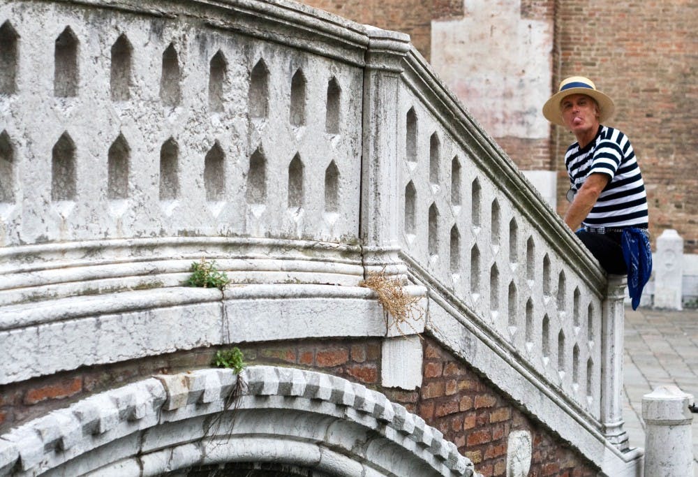 	A gondolier takes a bubblegum break in Venice.
