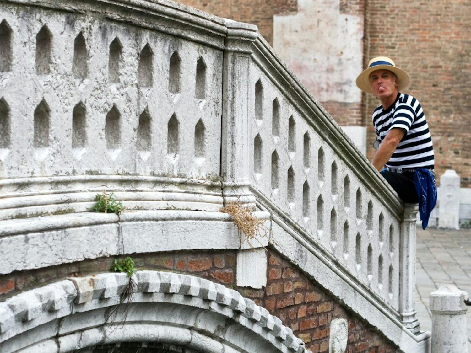 	A gondolier takes a bubblegum break in Venice.
