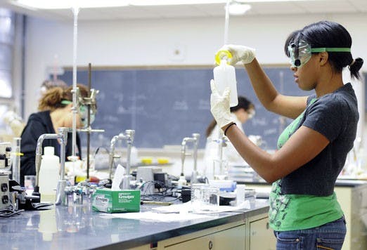 Student Janelle McLean measures chemicals during a chemistry lab, taught by a teaching assistant, on Oct. 6. 