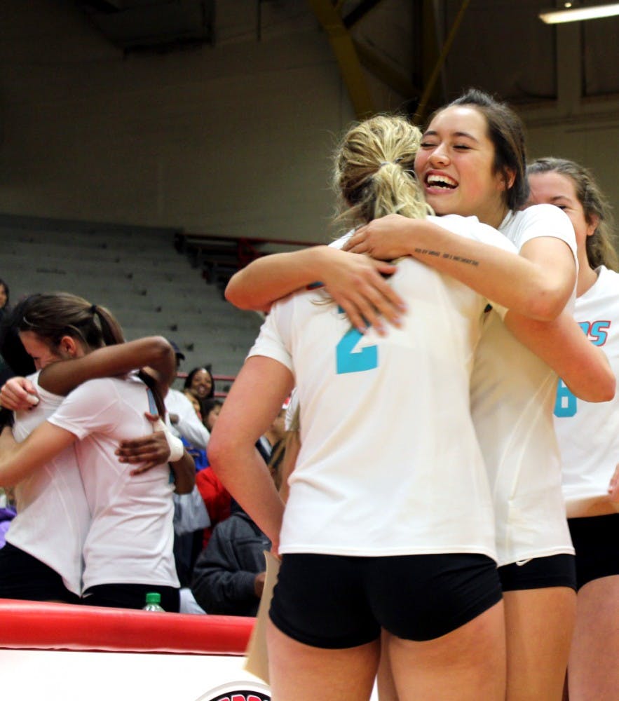 Senior Hannah Johnson is embraced by sophomore Eastyn Baleto after playing her last home game at Senior Night in Johnson Gym Wednesday night. The Lobos swept the series against the Utah State Aggies.