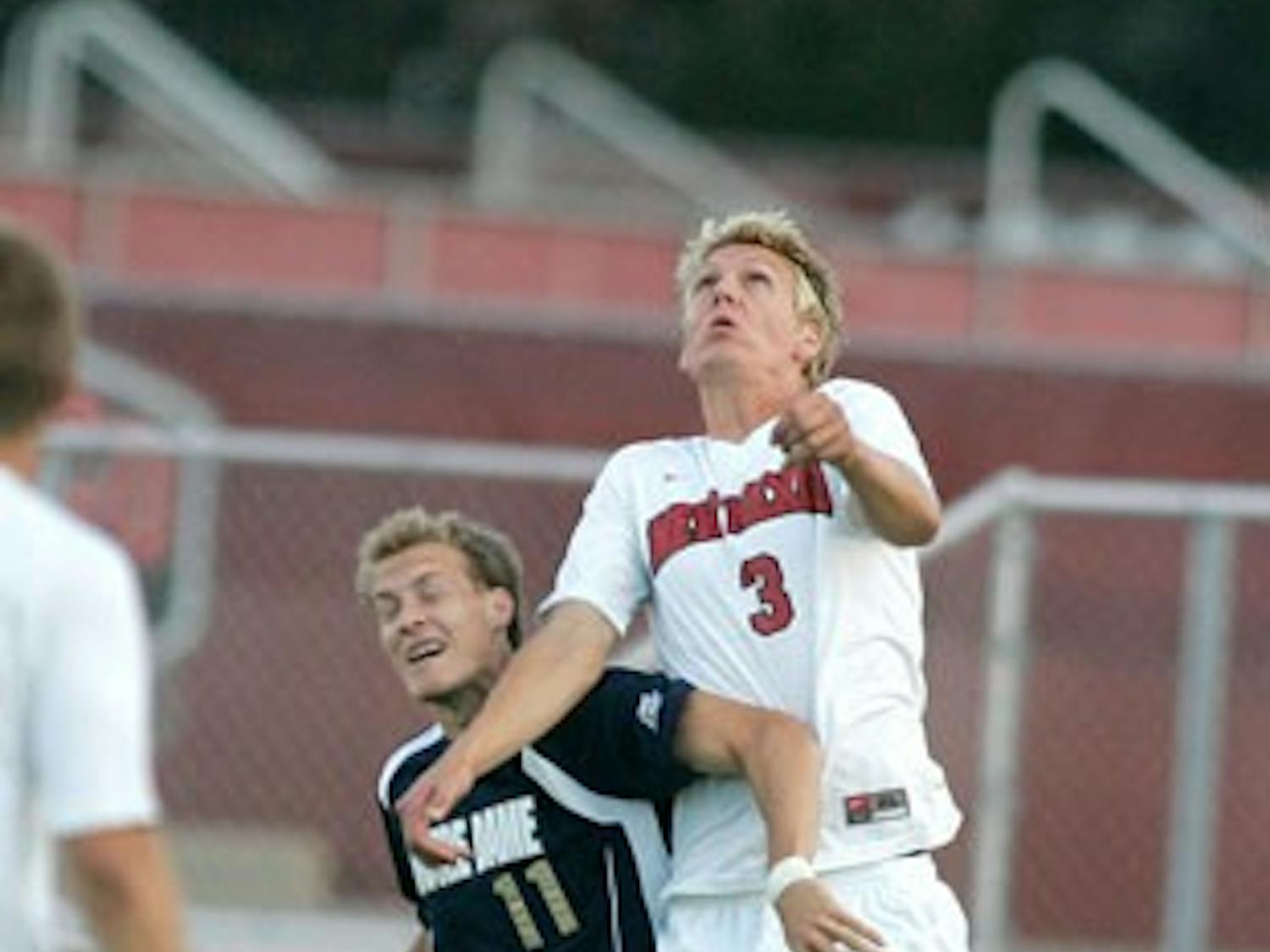 UNM goalkeeper Eric Staver blocks a shot by Notre Dame's Bright Dike in the Lobos' lone exhibition game Wednesday. The Lobos eventually went on to lose in double overtime, 2-1.