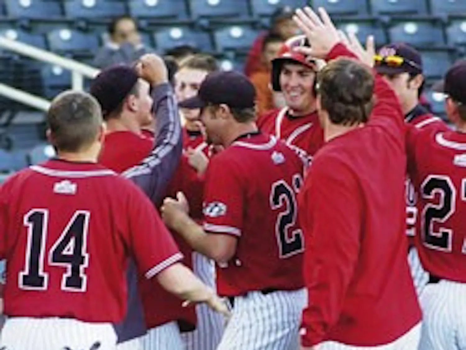 Former UNM slugger Chris Carlson, rear center, is congratulated by teammates after hitting a home run against the University of Northern Colorado on March 5.