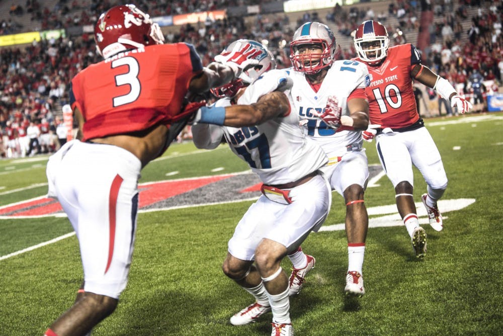 New Mexico defensive back Jadon Boatright (17) confronts Fresno State's wide receiver Josh Harper (3) during Friday’s game. The Bulldogs dominated the Lobos in both total offensive plays and yards, 593 total yards to the Lobos’ 382 total yards.