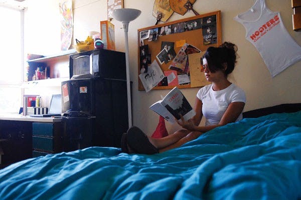Freshman Angelica Urioste relaxes in her dorm room in Santa Clara Hall after the first day of class Monday.